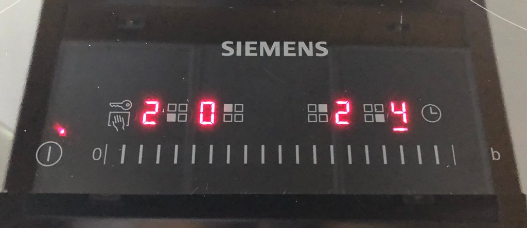 A picture showing the control panel of my Siemens cooktop, with the plates set to 2, 0, 2, 4.